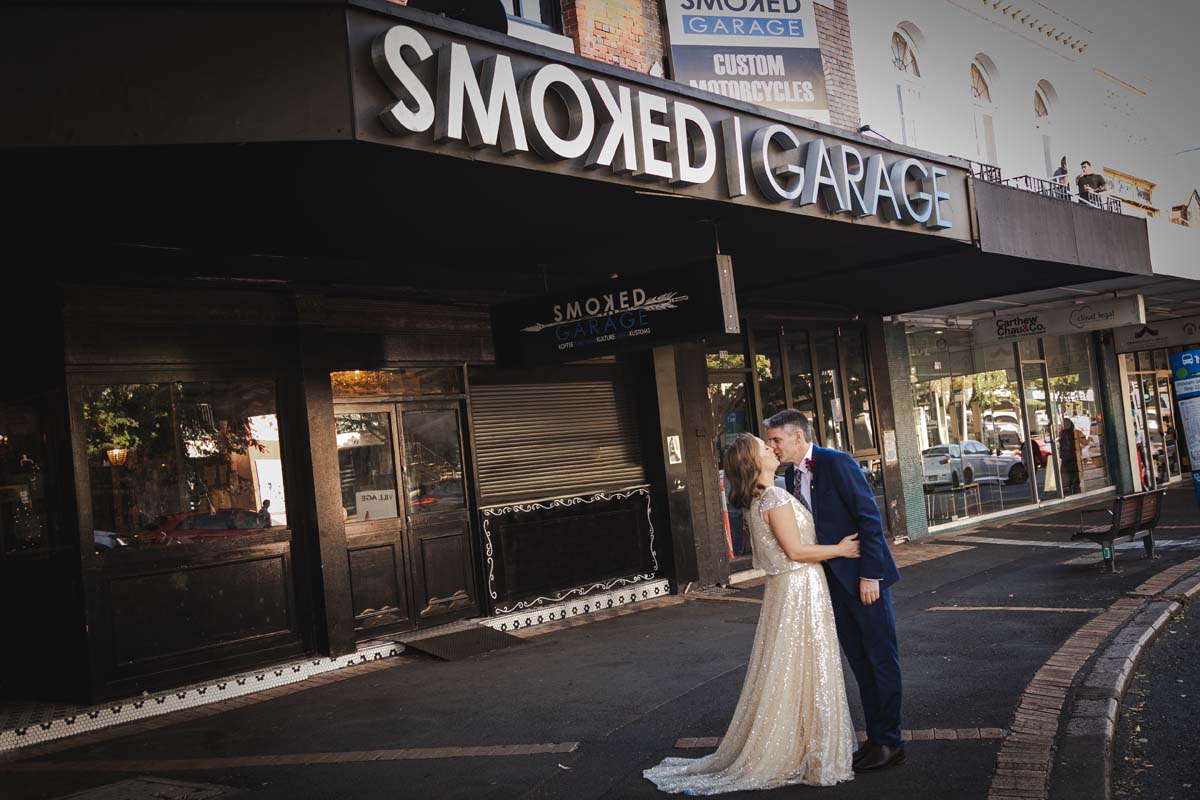 Wedding Photography couple kissing in front of venue