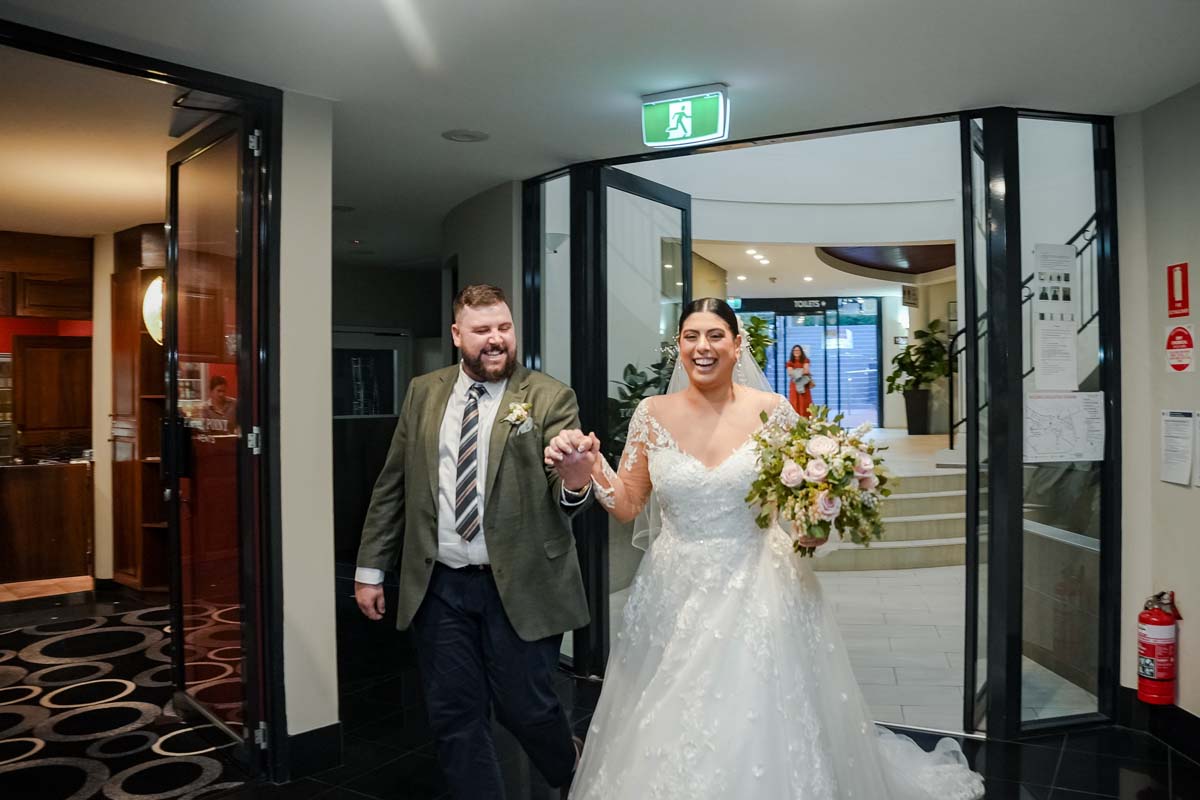 Wedding Photography bride and groom entering reception