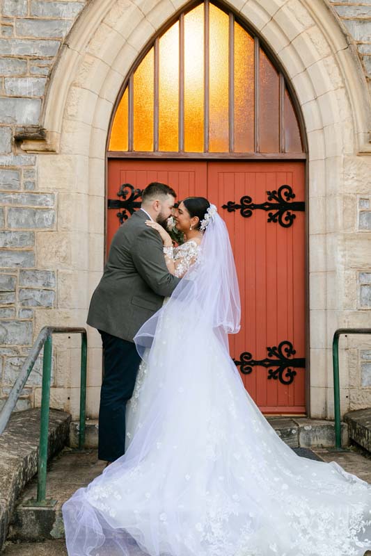 Wedding Photography bride and groom in front of church door