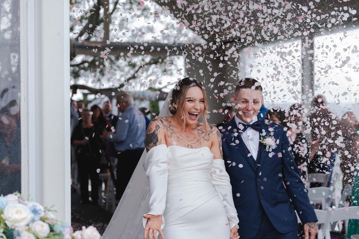 Wedding Photography bride and groom in confetti